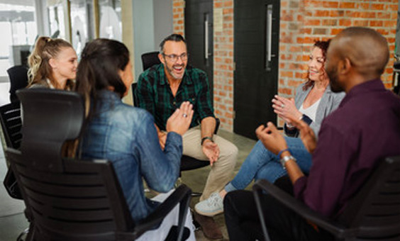 a small group of adults sitting in a circle